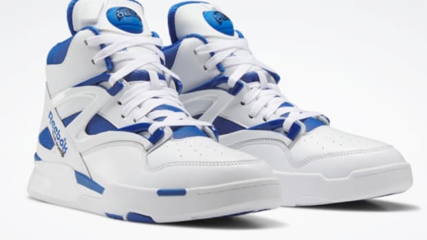 View of white and blue Reebok shoes.